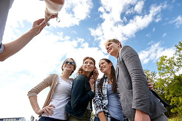 Image showing group of happy friends with camera taking picture