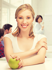 Image showing beautiful girl with green apple at school