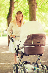 Image showing happy mother with stroller in park