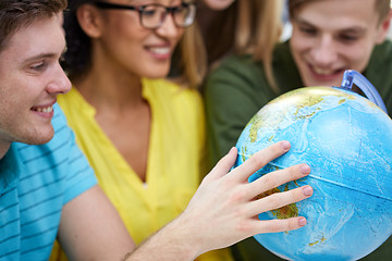 Image showing group of smiling students looking at globe