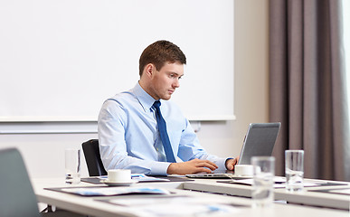 Image showing businessman with laptop working in office