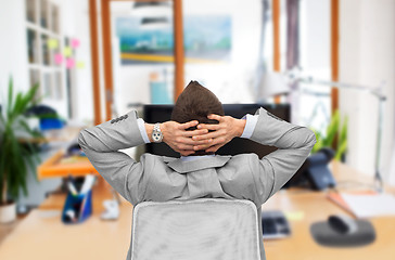 Image showing businessman sitting in office chair from back