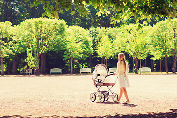 Image showing happy mother with stroller in park