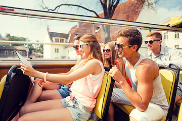 Image showing group of smiling friends traveling by tour bus