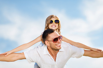 Image showing happy father and child in sunglasses over blue sky