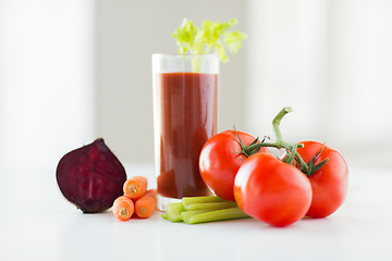 Image showing close up of fresh juice and vegetables on table