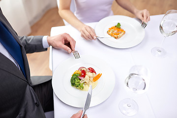 Image showing close up of couple eating appetizers at restaurant