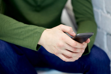 Image showing close up of male hands with smartphone