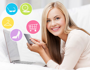 Image showing happy woman with laptop and credit card shopping