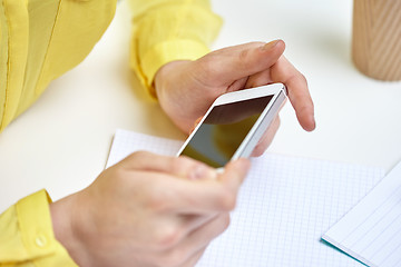 Image showing close up of female hands with smartphone at home