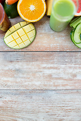 Image showing close up of fresh juice glass and fruits on table