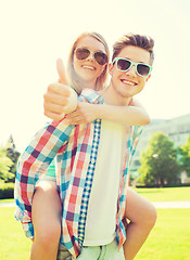 Image showing smiling couple having fun and showing thumbs up