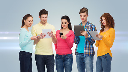 Image showing group of teenagers with smartphones and tablet pc