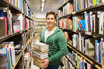 Image showing happy student or man with book in library