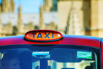 Image showing Famous cab on a street in London