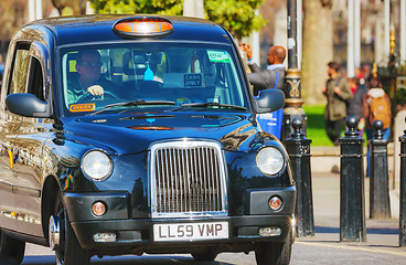 Image showing Famous black cab an a street in London