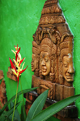 Image showing Thai tropical flower with traditional Buddhist image.