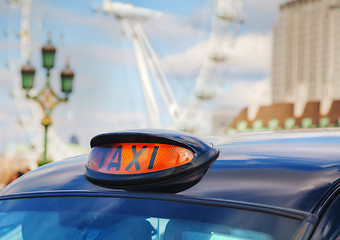 Image showing Famous black cab an a street in London