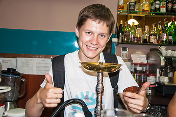 Image showing The young man behind the bar