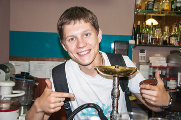 Image showing The young man behind the bar
