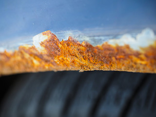 Image showing Extreme closeup of orange and brown rust on vehicle over wheel