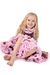 Image showing Happy girl in tutu skirt sitting on the floor