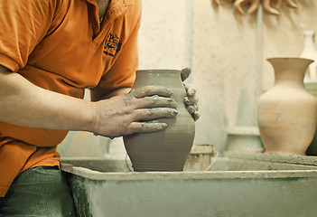 Image showing People at work: the production of ceramic vases on a Potter\'s wh