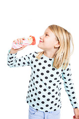 Image showing GIrl eating strawberry ice cream