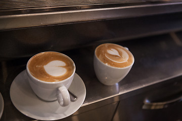 Image showing Delicious coffee cups with hearts