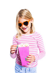 Image showing Girl eating pop corn and smiling