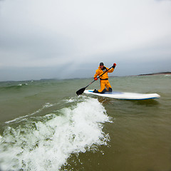 Image showing Woman stand up paddle boarding