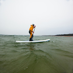 Image showing Woman on a stand up paddle