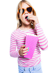 Image showing Girl eating pop corn