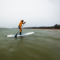 Image showing Woman on a stand up paddle board