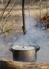 Image showing Cooking in sooty cauldron on campfire