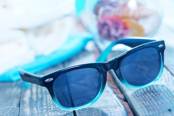 Image showing sun glasses and flip flops 