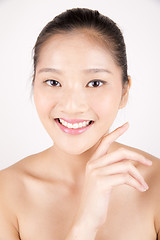 Image showing Beautiful young Asian girl with one hand on face