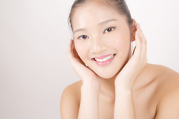 Image showing Beautiful young Asian girl with both hands on face