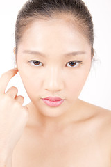 Image showing Beautiful young Asian girl with one hand on face