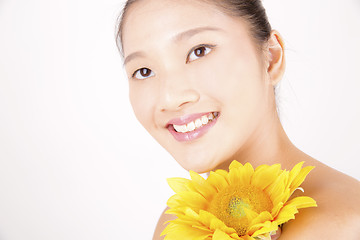 Image showing Beautiful young Asian girl with bright yellow sunflower