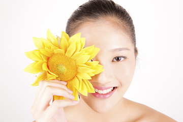 Image showing Beautiful young Asian girl with bright yellow sunflower