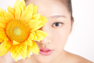 Image showing Beautiful young Asian girl with bright yellow sunflower