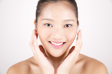 Image showing Beautiful young Asian girl with both hands on face