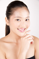 Image showing Beautiful young Asian girl with one hand on face