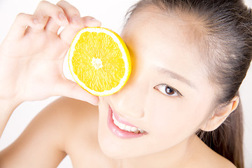 Image showing Beautiful young Asian girl holding orange slice over face