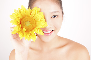 Image showing Beautiful young Asian girl with bright yellow sunflower