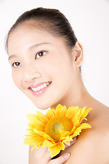Image showing Beautiful young Asian girl with bright yellow sunflower