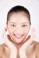 Image showing Beautiful young Asian girl with both hands on face