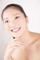 Image showing Beautiful young Asian girl with one hand on face