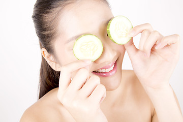 Image showing Beautiful young Asian girl holding cucumber slice over face